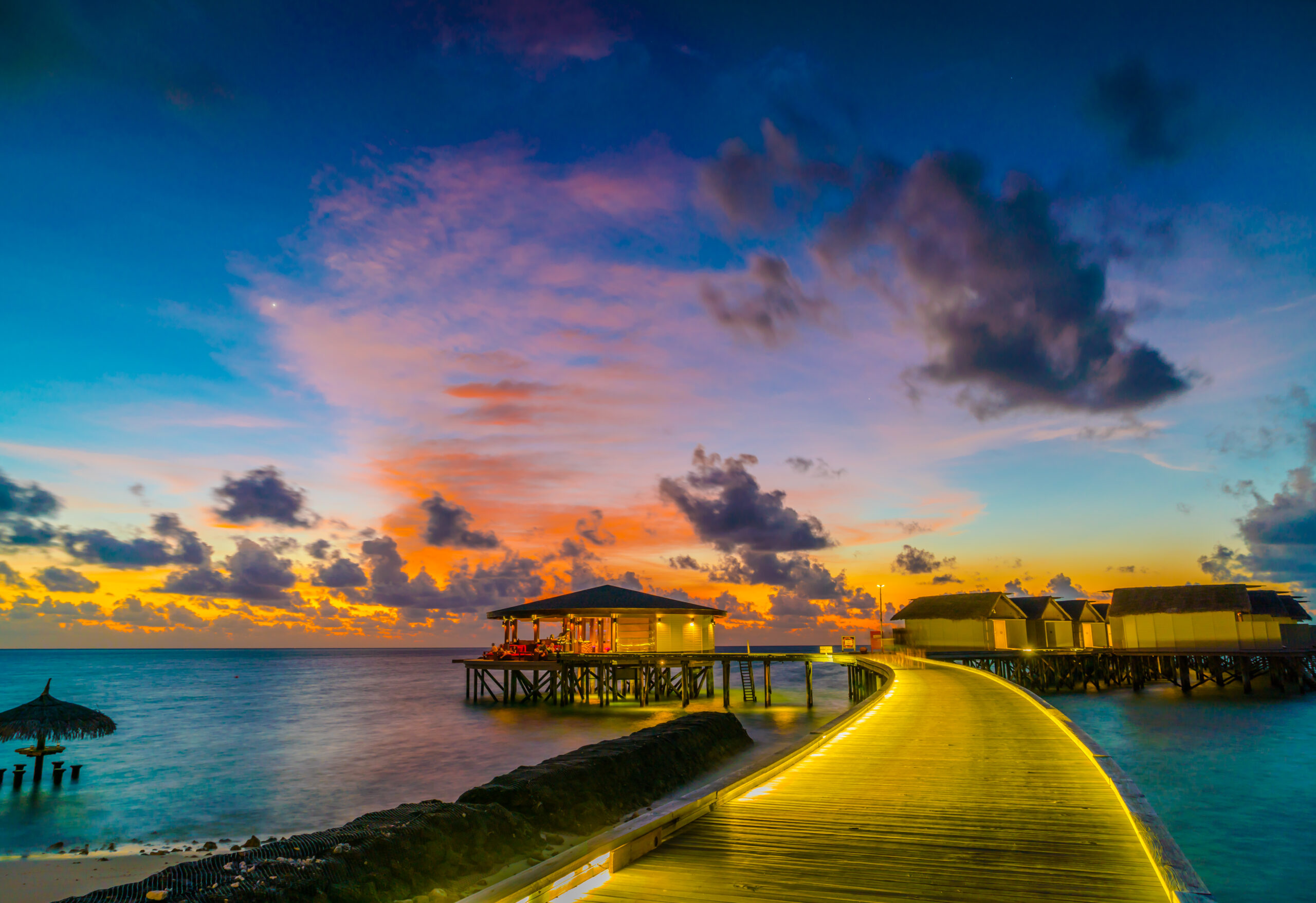 Beautiful water villas in tropical Maldives island at the sunset time